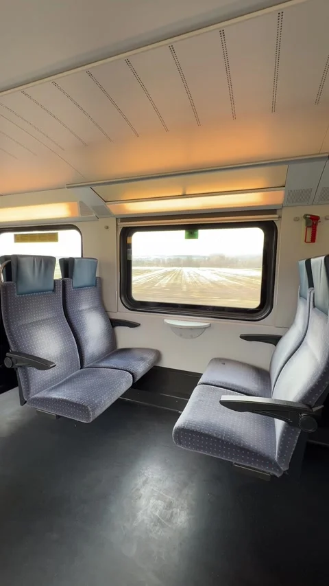 Train car interior view, empty seats and window, countryside background Stock Footage 305507193