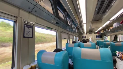 Train car vibes with seating interior and passengers Stock Footage 347543535