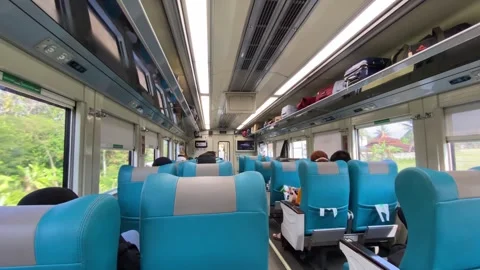 Train car vibes with seating interior and passengers Stockbeeldmateriaal 347543561