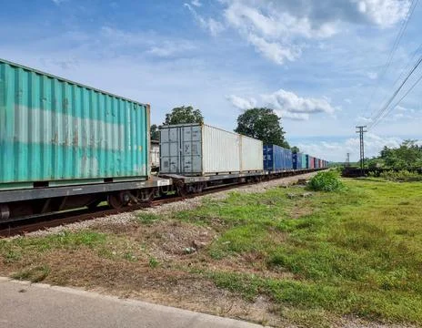 The train is carrying containers. diesel engine train of Thailand Fotos de archivo