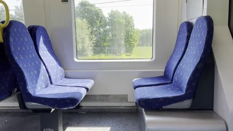 Train chairs and view through window. Comfortable chairs on a modern train Stock Footage 244773094