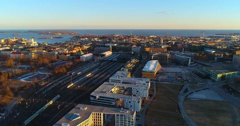 Train in a city, C4k aerial, reverse, drone shot, following trains leaving th Stock Footage 112226725