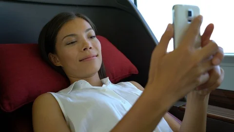 Train commute first class woman using phone texting on mobile phone app Stock Footage 101815968