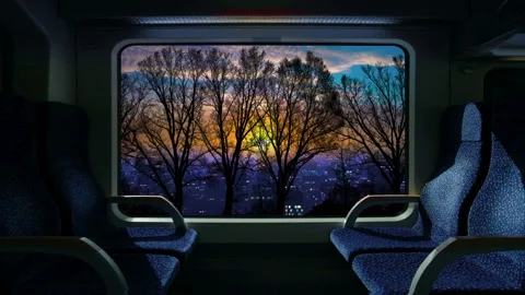 Train compartment window. 4K. Loop. Sunrise or sunset on a train journey. Stock Footage 168359415