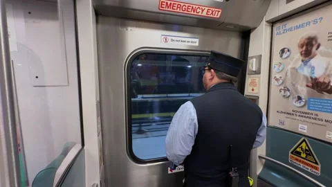 The Train Conductor is Actively Observing the Scenery Outside the Trains Window Vídeo Stock 295075534