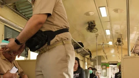 Train Conductor Checking Tickets for Passengers Inside a Bangkok Commuter Train Video stock 327691817