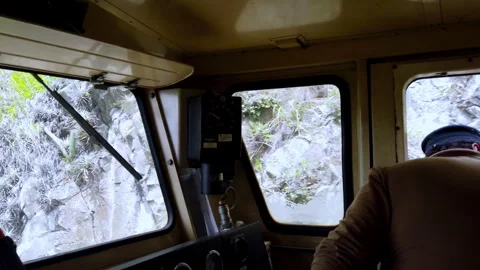 Train conductor driving through rocky landscape in Alausi, Ecuador, view Stock Footage 266128270