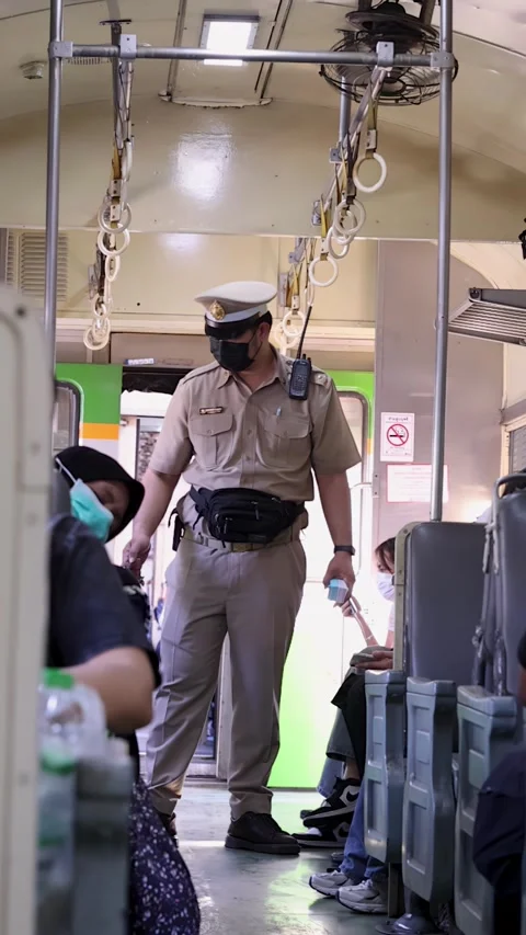 Train Conductor Inspecting Tickets on a Local Commuter Train in Bangkok Stock Footage 326080605