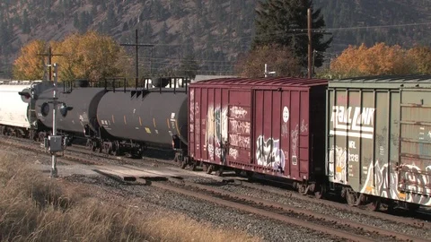 Train Crawling Along Tracks in Western Montana Stock Footage 90024604