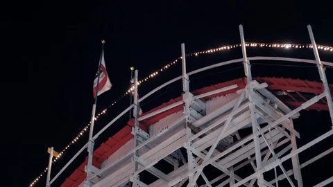 Train crests over the top of iconic wooden coaster Giant Dipper in Santa Cruz Stock Footage 95699004