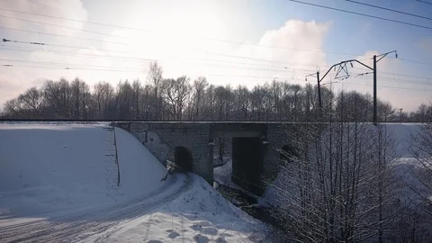 Train cross the bridge at sunny winter day Stock Footage 85704790