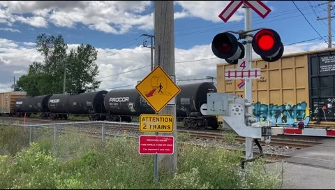 The train crossed the intersection with the road/ level crossing Stock Footage 137665445