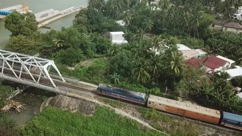 The train crosses the bridge over the river and goes into the tunnel Stock Footage 235461340