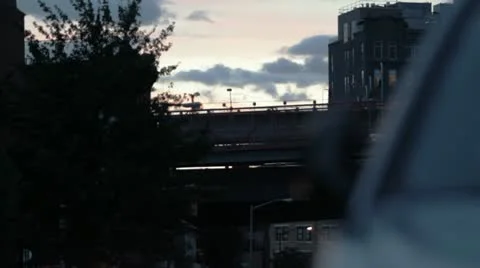 Train crosses over New York City bridge in dusk. Stock Footage 10936738
