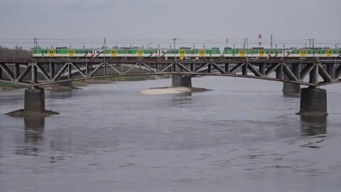 A train crosses a railway bridge over a river. Stock Footage 319100166