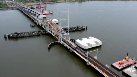 Train crossing Bridge with new one being built next to it in Perth Amboy, Video stock 241228430