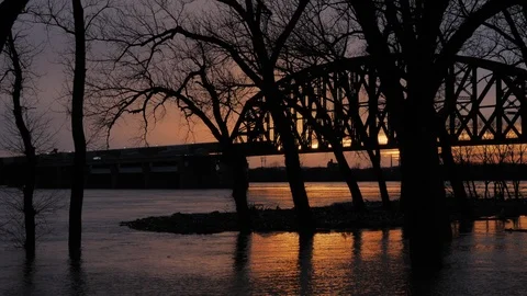 Train Crossing Bridge over Flooded Ohio River at Sunset near Louisville Stock Footage 88670225