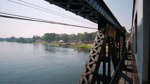 Train crossing the bridge over the river Kwai in Kanchanaburi, Thailand Stock Footage 322518767