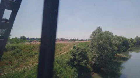 Train crossing a bridge over a river in the Italian countryside Stock-Footage 343342096