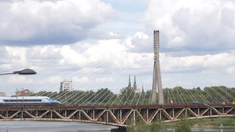 Train crossing bridge over Vistula River in Warsaw Poland on cloudy day Stock Footage 285126425