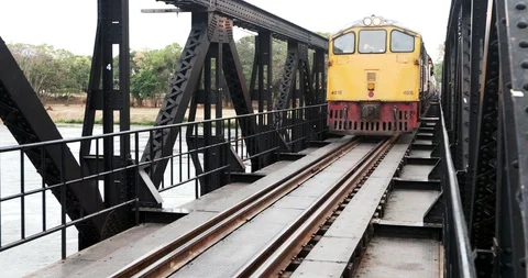 Train crossing the Bridge on the river Kwai in Kanchanaburi, Thailand. Stock Footage 107967570