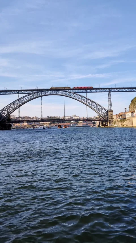 Train crossing Dom Luis I bridge over Douro river in Porto, Portugal Video stock 335636836