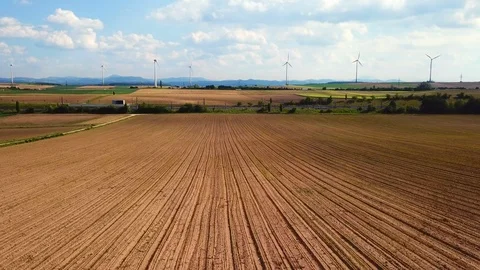 Train crossing in front of windturbines and fields Stock Footage 108590063