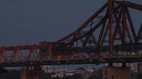 Train Crossing Historic Long Bien Bridge Over the Red River in Hanoi, Vietnam Stock Footage 344743058