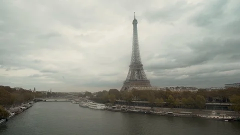 Train crossing La Seine over bridge with Eiffel Tower in the background, Paris Stock Footage 106229996