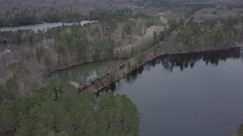 Train crossing land bridge Stock Footage 85556681