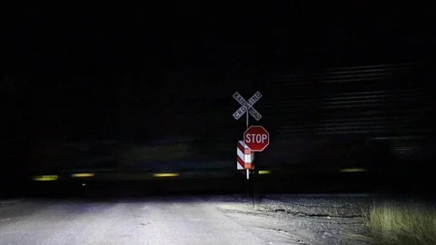 Train Crossing at night, speeding freight, loopable, static Stock Footage 118551554