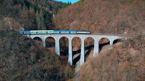 Train crossing old stone arched bridge Stockbeeldmateriaal 105248432