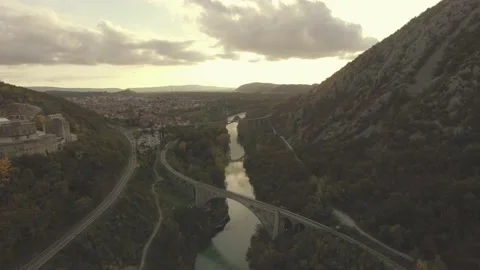 Train crossing old stone bridge at sunset Stock Footage 142065331