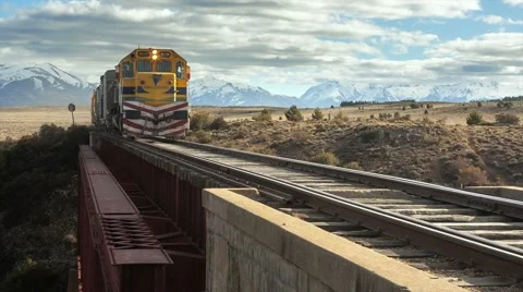 Train crossing passing old bridge over the river scenic mountains nature Stock Footage 67253817
