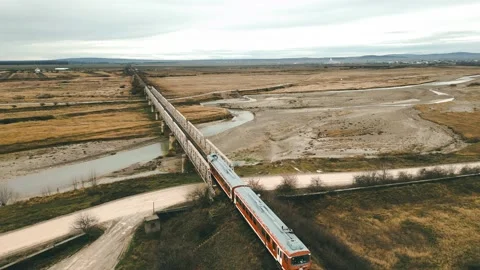 Train crossing the railway bridge over the Prahova river Stock Footage 228915486