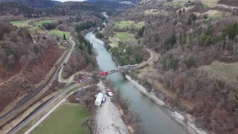 Train Crossing Rhine River Bridge with Cyclist on Bike Path Aerial 스톡 동영상 330749498