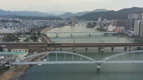 Train crossing the Seta river in the early evening in Shiga, Japan Vidéo 128934956