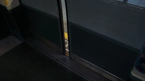 Train door closes with “Mind the Gap” warning visible on the platform. Stock Footage 319724969