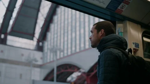 Train door closing on man looking out the train Stock Footage 130982366