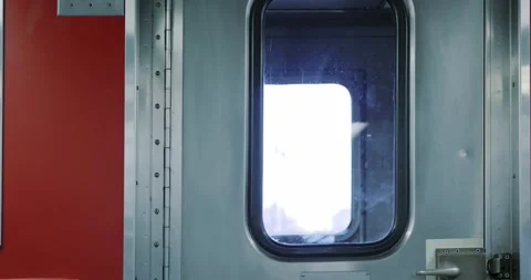 Train Door with Passing Scenery on Red Interior Stock Footage 323681760