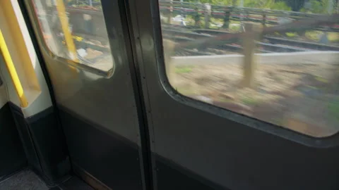 Train door view with motion blur from a moving platform outside. 스톡 동영상 319724786