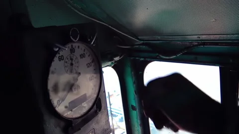 A train driver is adjusting a clock inside diesel electric locomotive EMD G16. Stock Footage 237632197