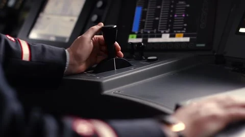 Train driver hand on thrust lever of dashboard controls in cockpit cabine Stock Footage 58507182
