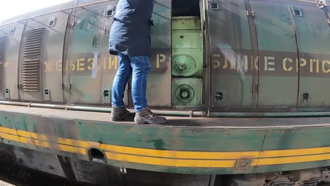 Train driver is opening diesel engine space at locomotive EMD G16. Video stock 237478480