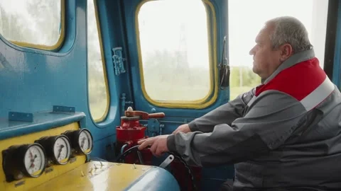 Train driver operating controls in the cabin of a blue vintage locomotive. Stock-Footage 272756758