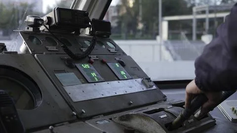 Train driver operating levers and controls in cabin. Clip Stock Photos