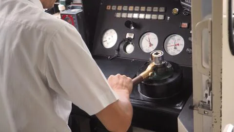 Train driver or crews is working on the train at control panel. Stock Photos