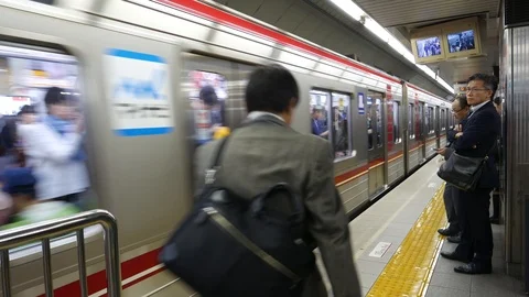 Train driver points to the platform as the train stops in Osaka, Japan. Stock Footage 98577972