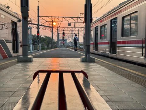 Train Driver Waiting Between Commuter Trains at Sunset Platform Stock Photos