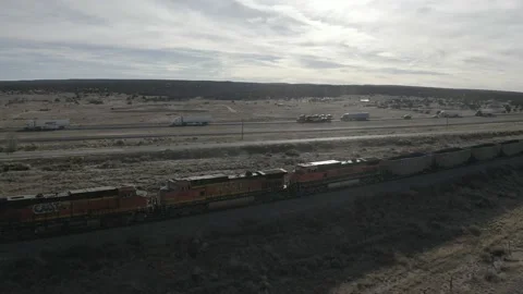 A train drives outside of a western US town Stock-Footage 161446187